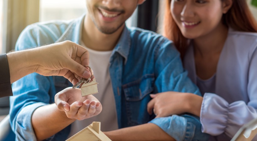 Couple getting the keys on a property.