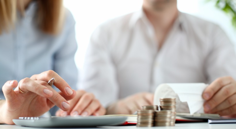 Two people working on costs and tasks associated with loft conversion. 