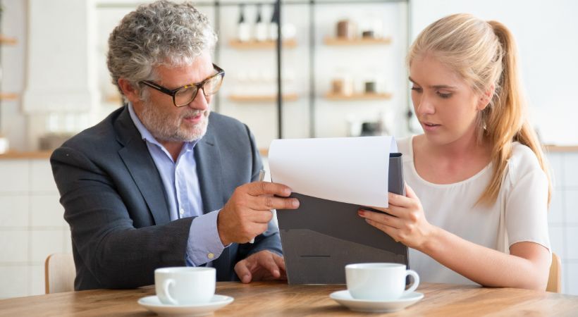 Man and woman going through financial plans together.