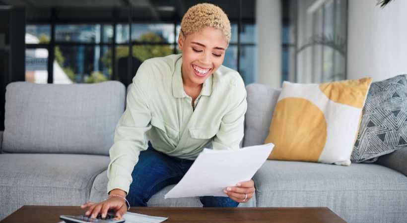 Woman calculating and paying her tax bills. 