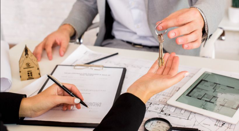 Someone handing over keys for property development